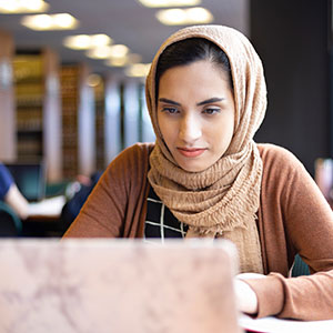 A student on their laptop. Links to Beneficiary Designations designations.jpg