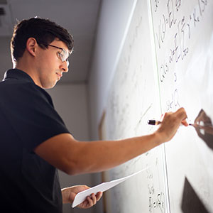 A student writing on a board. Links to Gifts from Retirement Plans reitrement.jpg